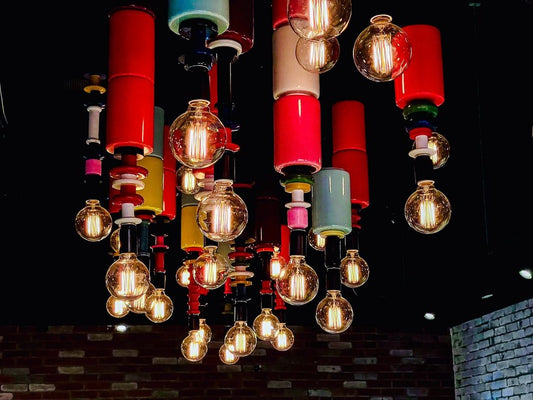 Light Installation with multiple different ceramic lamps of different colors with  Edison bulbs 