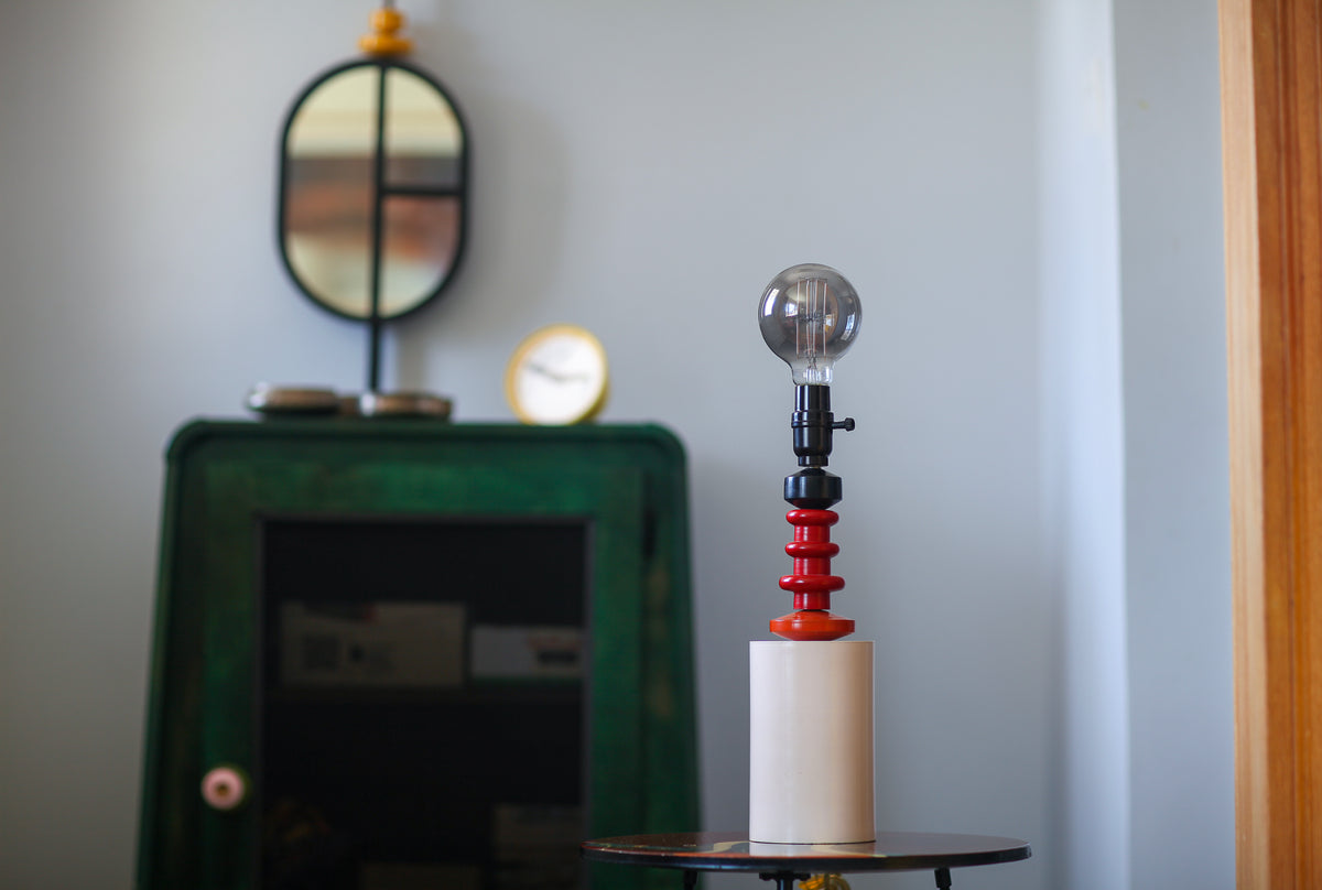 Decorative lamp with spherical shade on a small table.